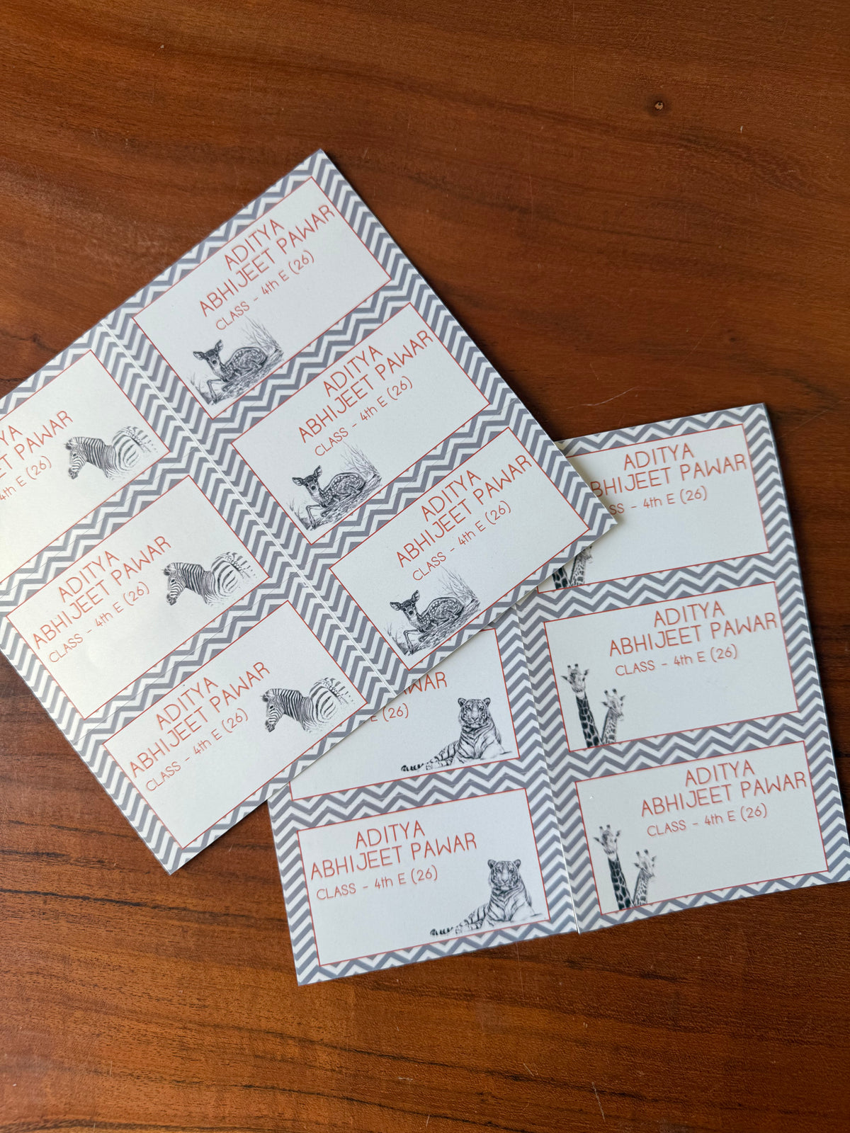personalised book labels in grey white them with illustraions of a zebra deer tiger and giraffe