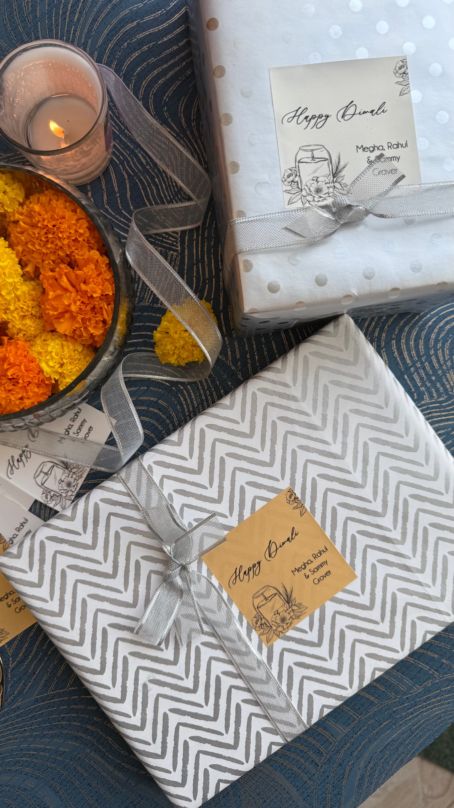 Gift boxes with chevron patterns and ribbons on a textured surface