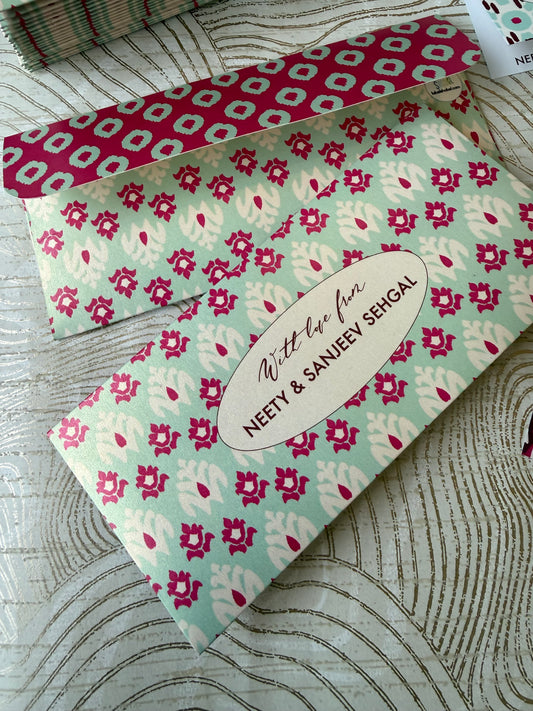 ikat Floral patterned money envelope with personalisation on a textured surface
