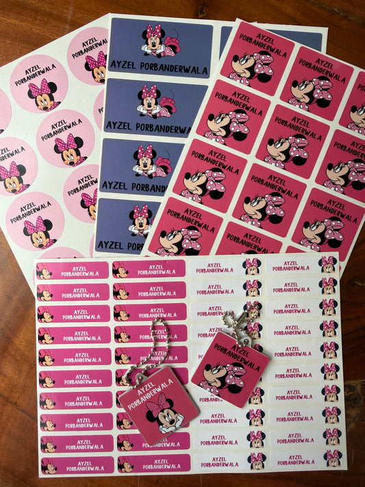 A collection of Minnie Mouse themed waterproof school name labels, including pink and blue rectangular tags, round stickers, and a small metal keychain, all featuring Minnie Mouse illustrations