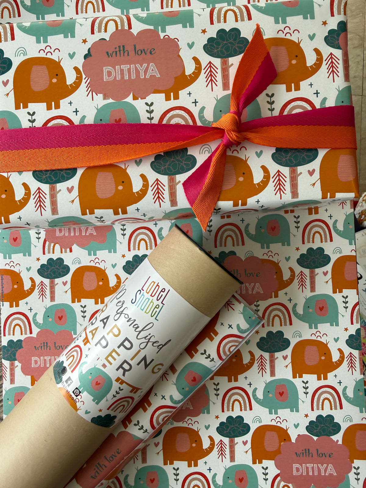 Gift wrapped in personalised wrapping apper with colorful elephant pattern and a ribbon