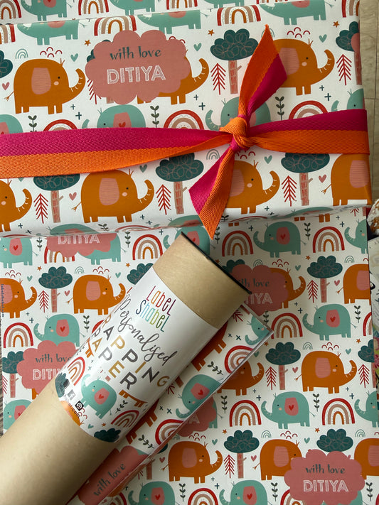 Gift wrapped in personalised wrapping apper with colorful elephant pattern and a ribbon