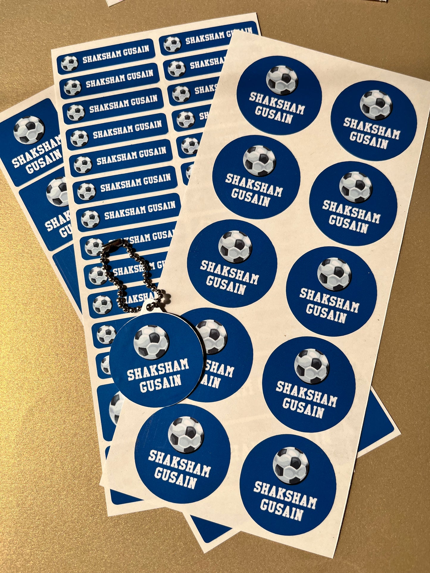 Sheet of blue and white stickers with text on a beige background