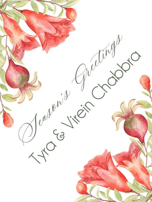 Floral design with pomegranates and their flowers with 'Season's Greetings' text on a white background