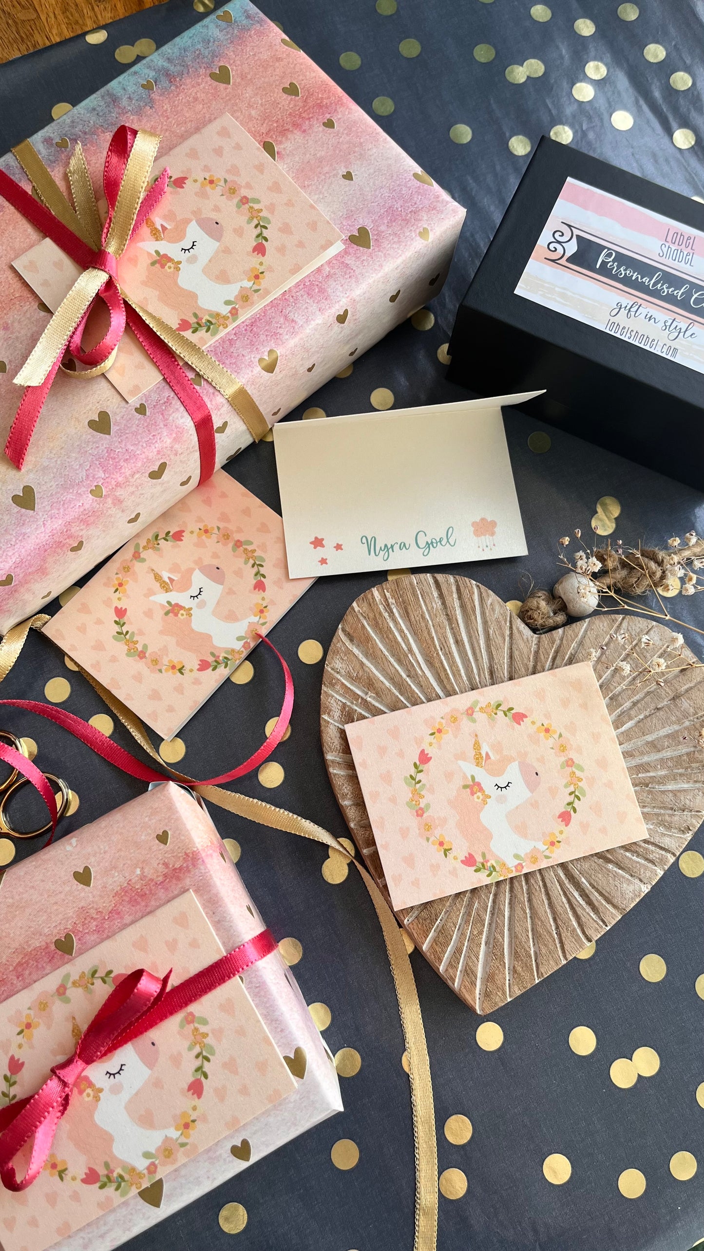 Unicorn gift tags on Gift boxes with ribbons and decorative packaging on a polka dot surface