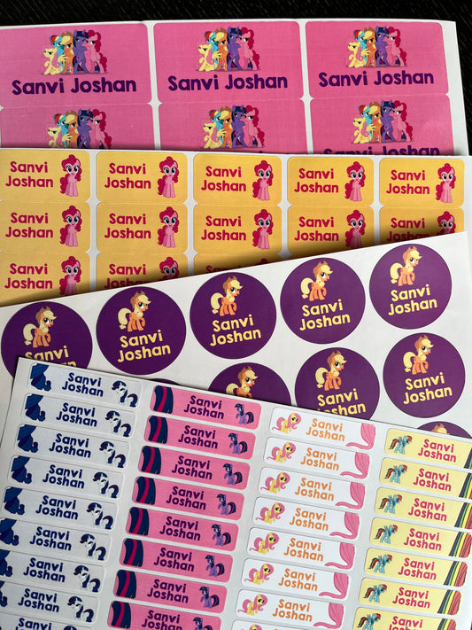 Custom printed sticker sheets featuring cartoon pony characters and the names 'Sanvi Joshan' in multiple colorways, including pink, yellow, purple, and blue.