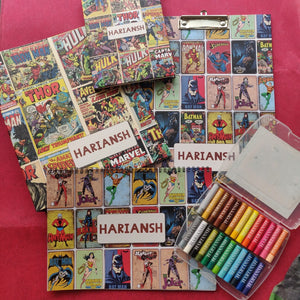 a set of 5 items clipboard notebook folder art book and box of personalised crayons with a comic book style avengers themed artwork