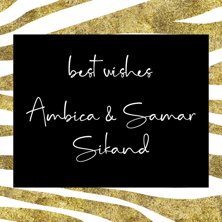 A square black card or sign with white cursive text reading 'best wishes Ambica & Samar Sikand,' centered on a gold glitter and white zebra-stripe background.