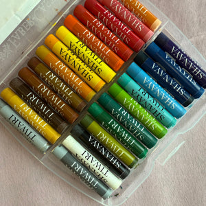 Set of pastel crayons in various colors with personalised name branding on a light background
