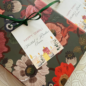 Floral gift box with a 'Happy Diwali' tag featuring candles and flowers.