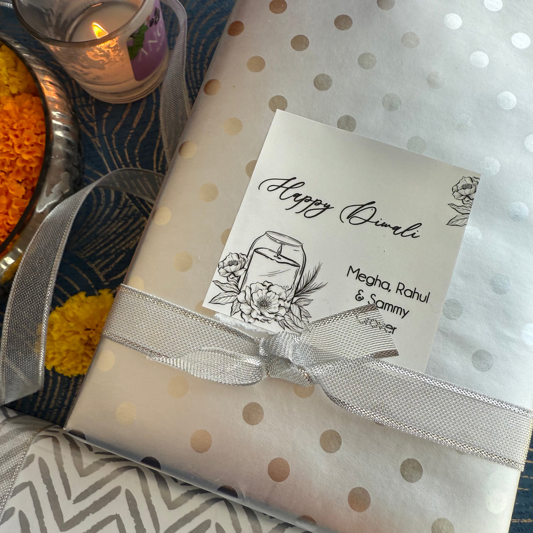 Gift wrapped in polka dot paper with a Diwali card, ribbons, and decorative items.