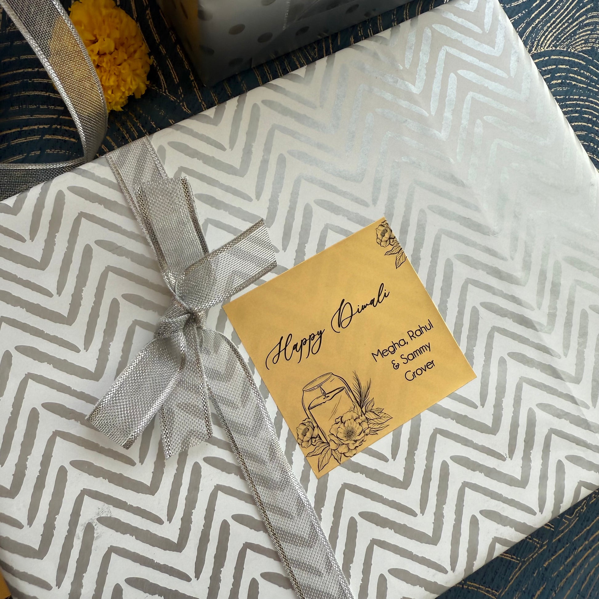 Gift box with chevron pattern and a decorative tag on a textured surface
