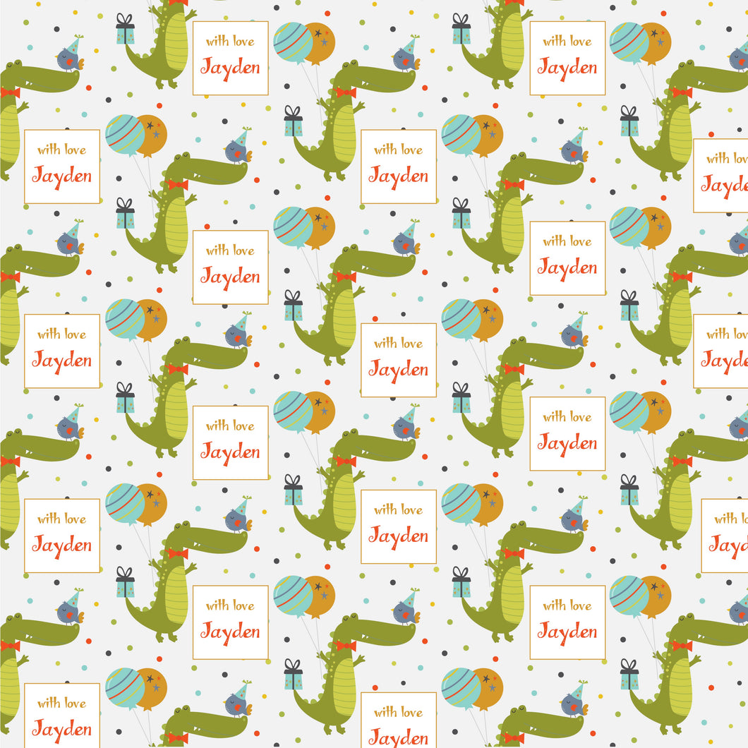 Personalised wrapping paper with a pattern of green crocodiles, blue and pink birds, and personalized text labels.