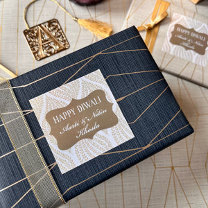 Beige and white diwali wishes gift label on a blue gift wrapped