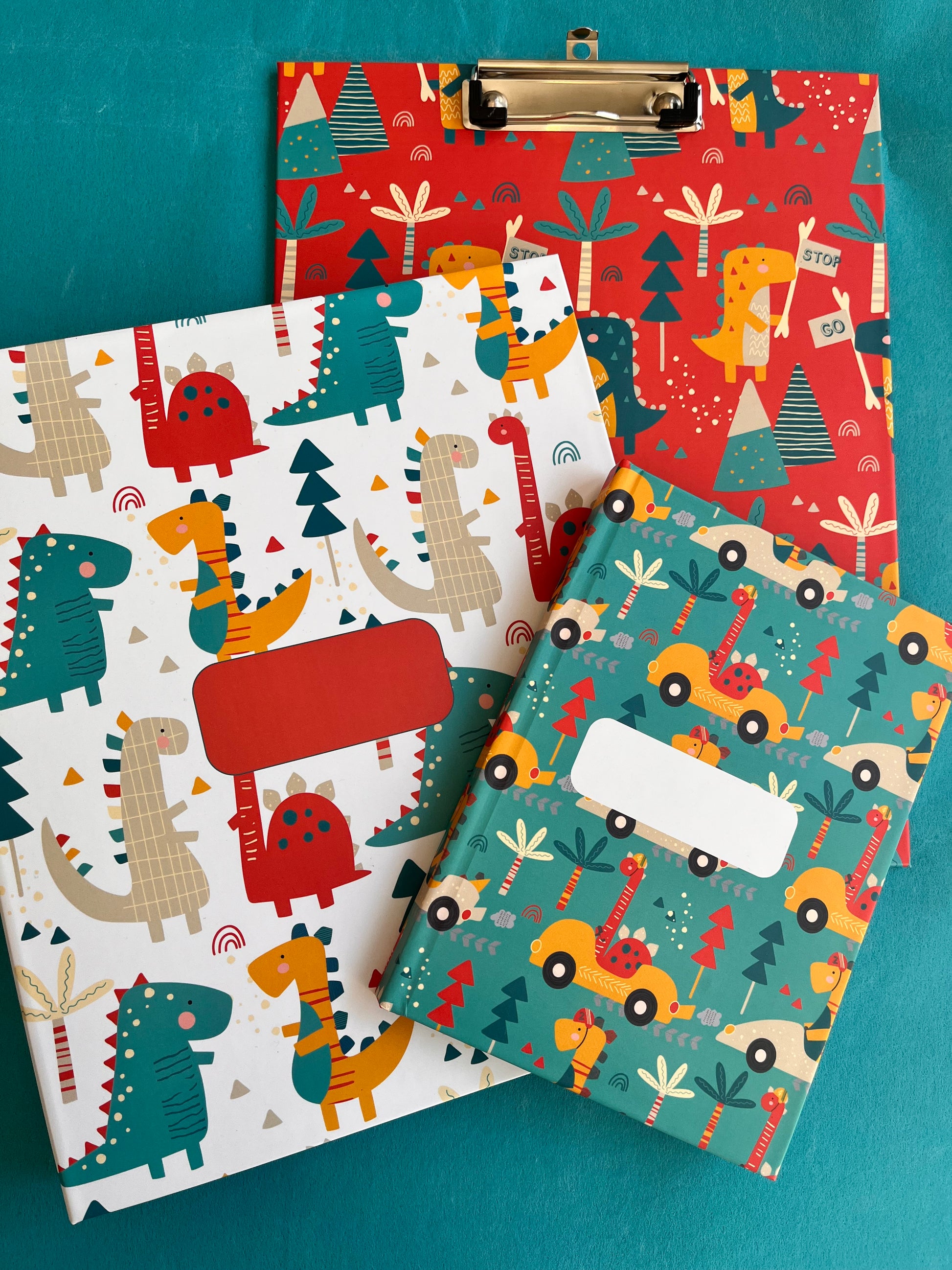 A set of file folder, note book clipboard in bright cheerful dinosaurs design