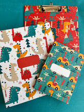 A set of file folder, note book clipboard in bright cheerful dinosaurs design