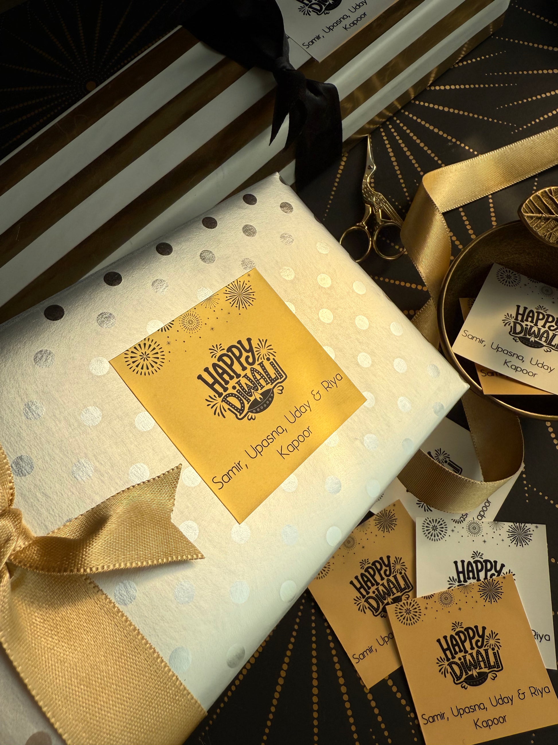 Gift box with polka dot pattern, gold ribbon, and 'Happy Hanukkah' card.