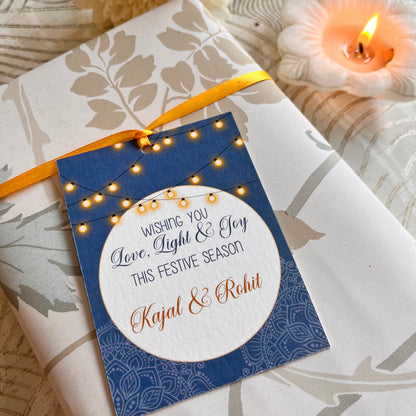 BLUE BACKGROUND with white circle and a string of ights ribbon gift tag