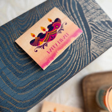 Greeting card with Diwali design on a textured surface