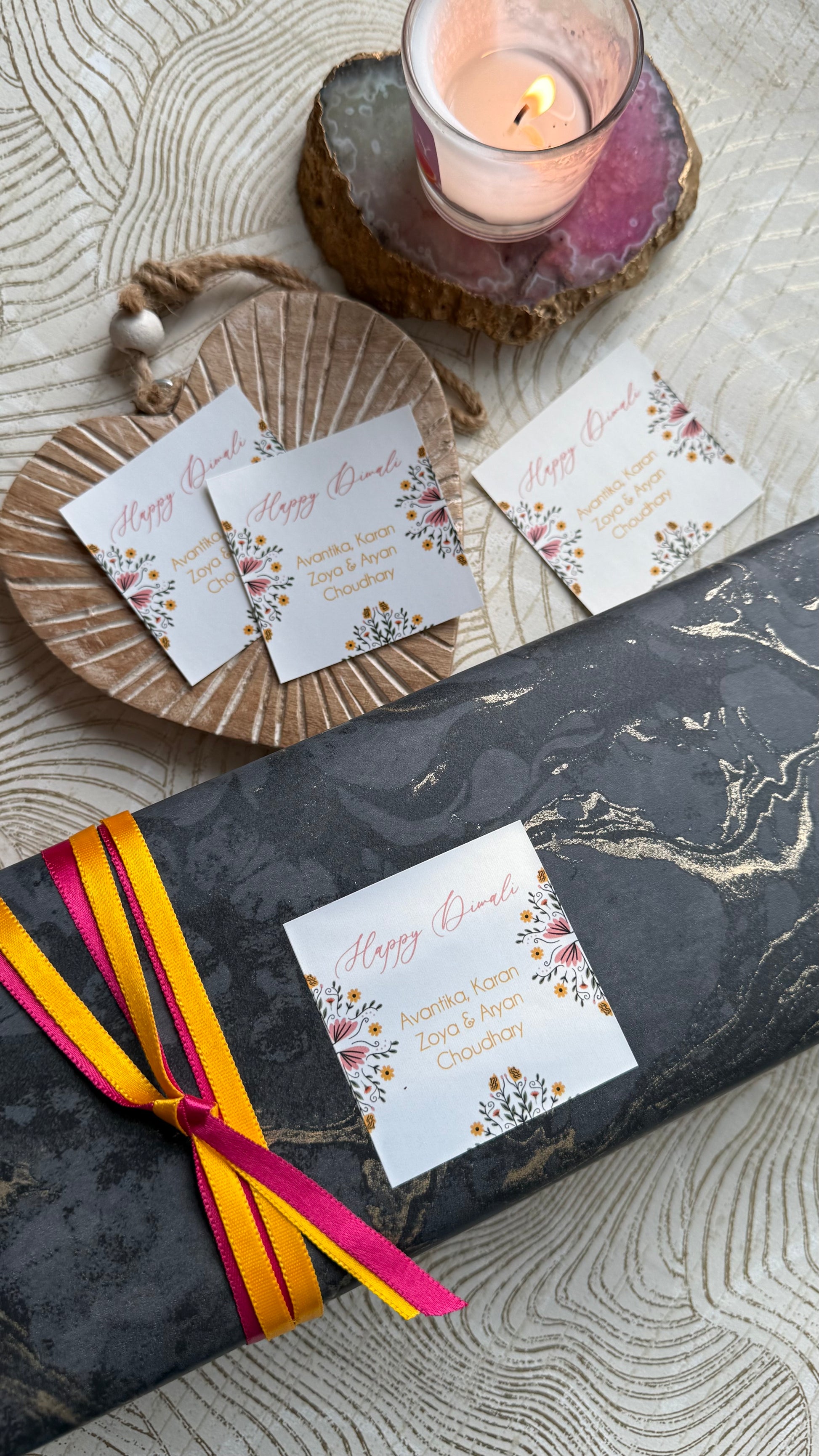 Gift box with floral cards on a textured surface
