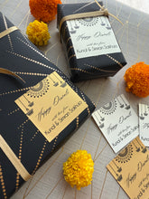Gift boxes with decorative paper and flowers on a textured surface
