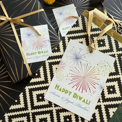 Gift cards with 'Happy Diwali' text and firework designs on a patterned surface.