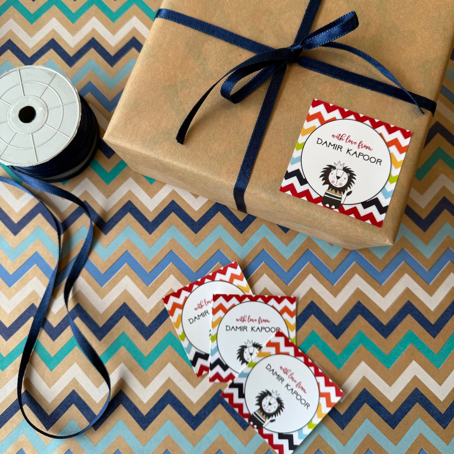 Gift wrapped in brown paper with blue ribbon on a zigzag patterned surface with a cute lion illustration