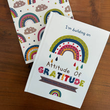 Gratitude journal front cover with a colourful rainbow and back view with multiple rainbows