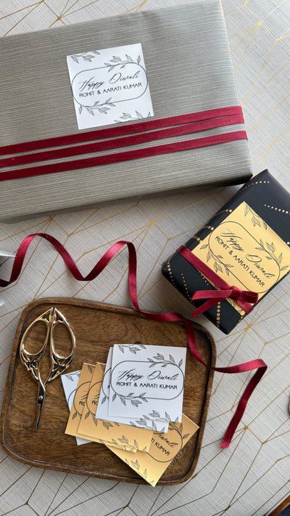 Gift box with red ribbon and decorative cards on a wooden tray