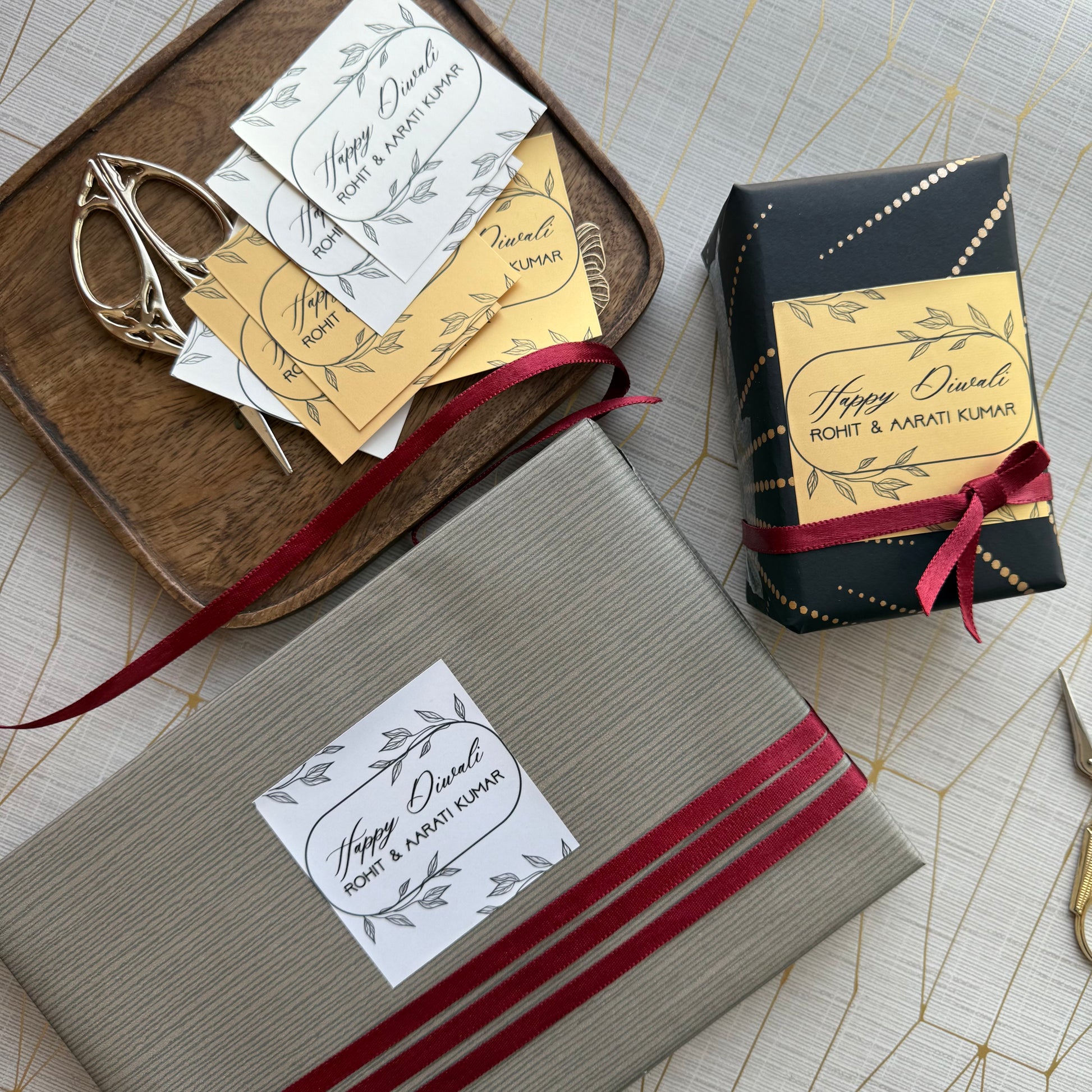 Gift boxes with personalized labels and decorative ribbons on a textured surface