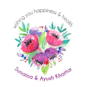 A gift label with a floral design in purple hues and text that reads 'wishing you happiness & health - Sunaina & Ayush Khattar'.