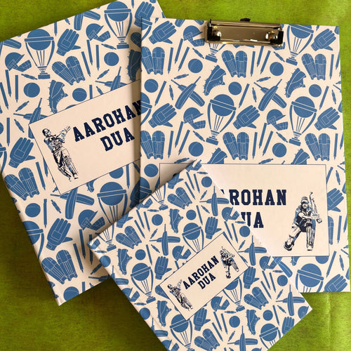 A set of school supplies with a blue and white design, including a notebook, clipboard, and a ring folder, all personalized with 'Aarohan DuA' written on the covers.