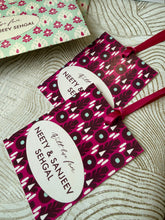 Gift packaging with 'Neety & Sanjeev Sehgal' text on a textured surface