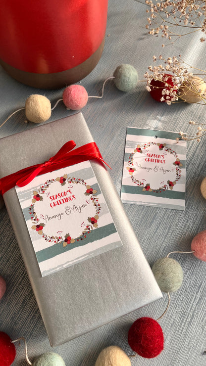 Xmas gifts ribbon tag featuring a wreath in xmas colours on a silvery  grey background