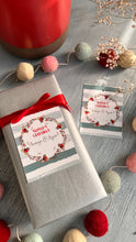 Xmas gifts ribbon tag featuring a wreath in xmas colours on a silvery  grey background