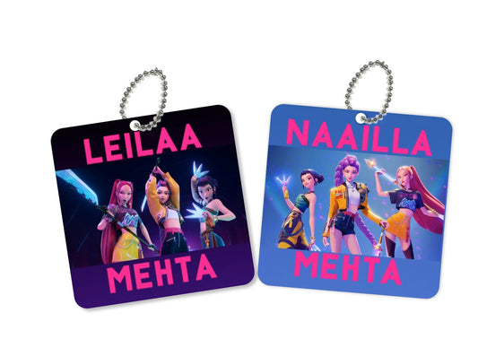Two square metal bag tags with ball chains, featuring colorful fantasy character illustrations and the names 'LEILAA' and 'NAAILLA' in pink text.
