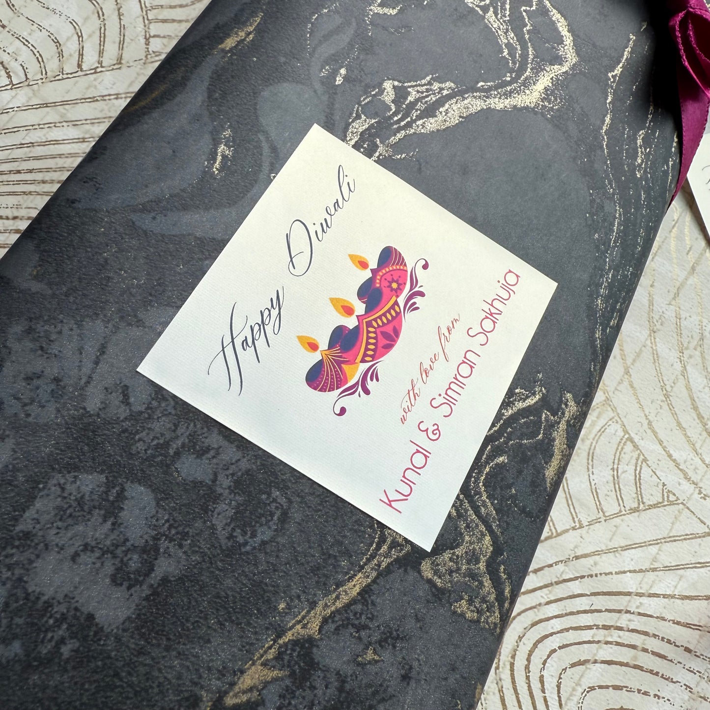 Greeting card with 'Happy Diwali' design on a decorative surface