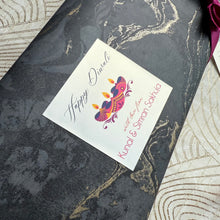 Greeting card with 'Happy Diwali' design on a decorative surface
