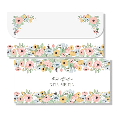 A set of gift envelopes with a floral design, including an envelope with a personalized name, 'Nita Mehta', printed on it.