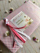Lotus flowers and leaves  design on a gift label used on a Gift wrapped in pink and white polka dot paper with a ribbon 