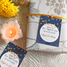 Diwali wishes gift tag with a ribbon on a navy blue background with string of lights