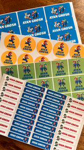 Collection of Mario themed branded stickers on a wooden surface