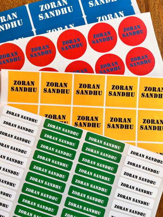 waterproof school name labels personalised with a aname in bold colours white, red, yellow, and green backgrounds