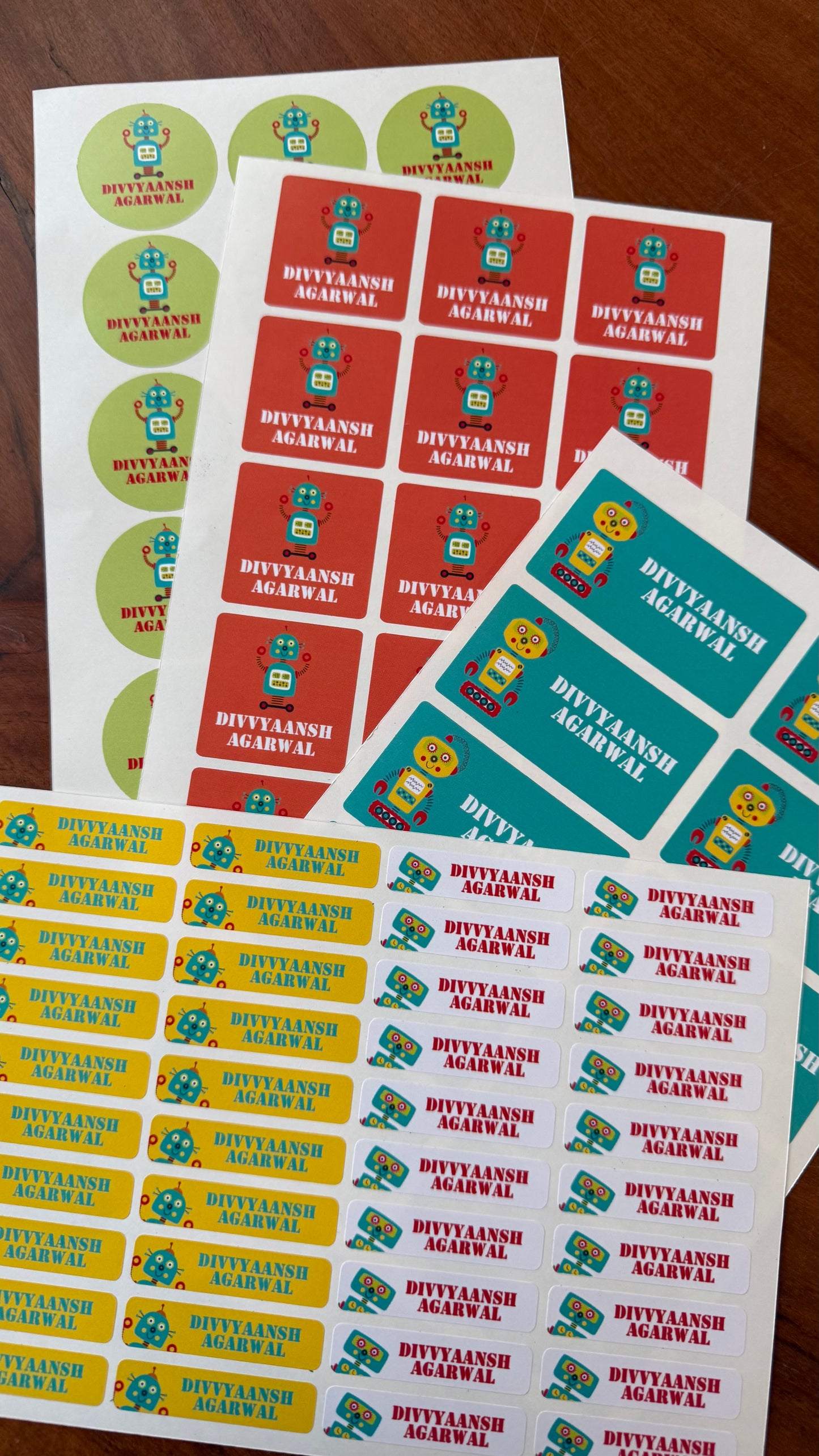 colourful waterproof name labels for school with bright colours in red yellow green and teal with a name and ifferent robot cartoons