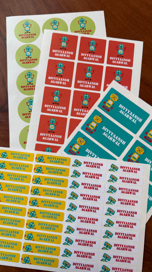 colourful waterproof name labels for school with bright colours in red yellow green and teal with a name and ifferent robot cartoons