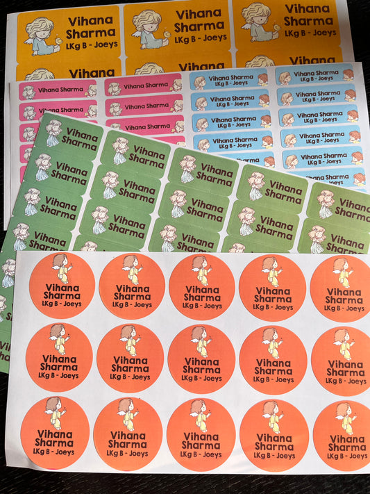 A set of printed label sheets featuring the name 'Vihana Sharma' with a cartoon angels illustration shown in multiple color options including orange, green, pink, and blue.