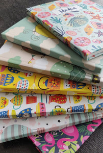 Stack of bright colourful notebooks in different prints