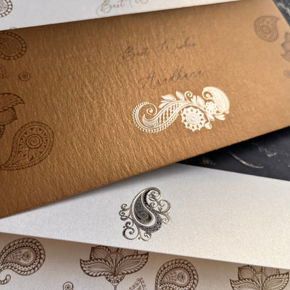 Close-up of paisley designs on textured paper.