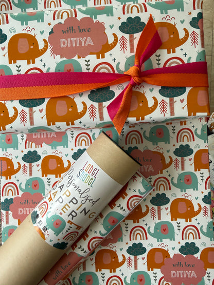 Gift wrapped in personalised wrapping apper with colorful  elephant pattern and a ribbon