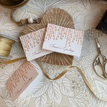 Season's Greetings cards with decorative elements on a patterned surface